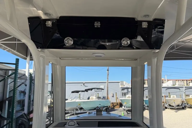 Slide: The Image of Interior view of 2026 Key West 239 FSR boat, showcasing dashboard and overhead storage. - 31