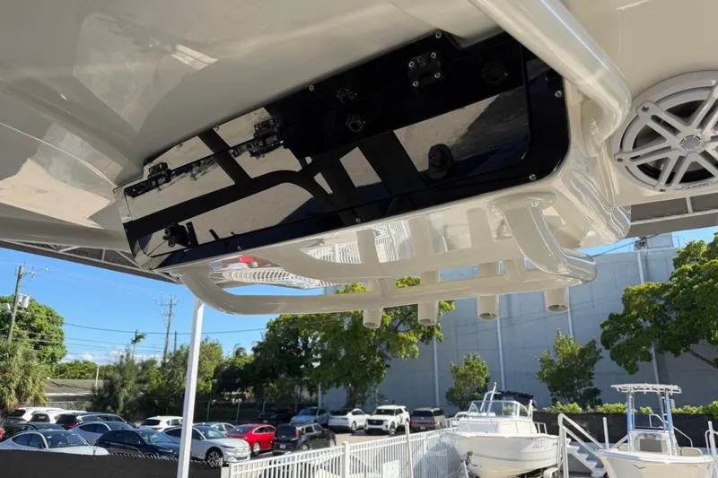 Slide: The Image of 2026 Key West 239 FSR boat with rod holders and speaker, parked outdoors. - 33