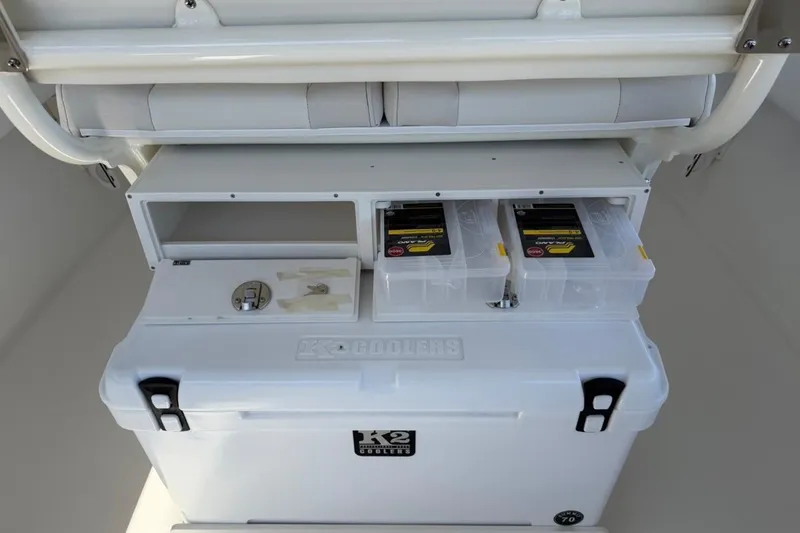 Slide: The Image of Storage compartment on a 2026 Key West 239 FSR boat with cooler and tackle boxes. - 36