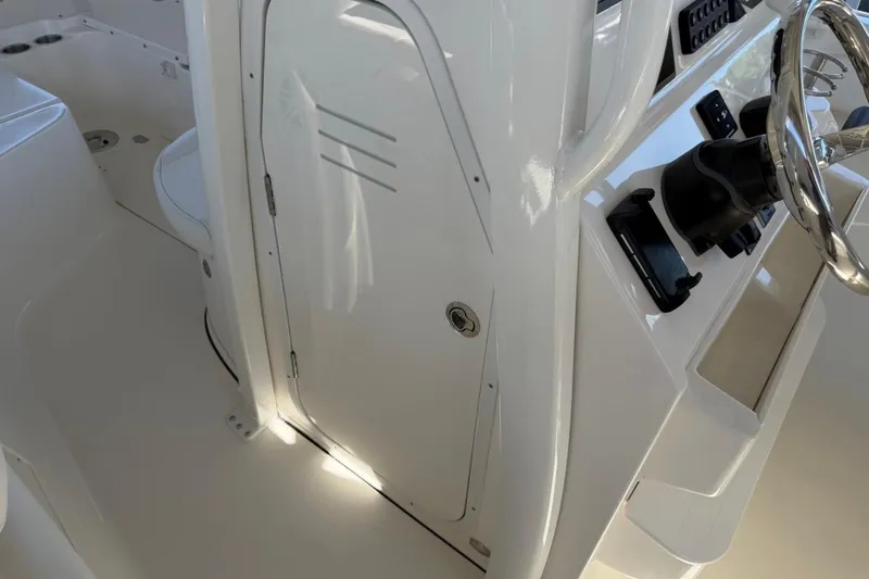 Slide: The Image of 2026 Key West 239 FSR boat interior with steering wheel and console details. - 38