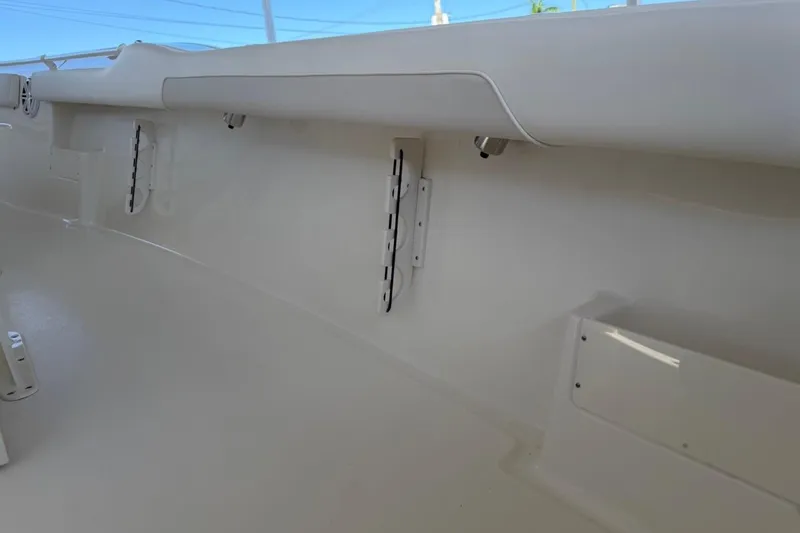 Slide: The Image of Interior view of 2026 Key West 239 FSR boat, showcasing sleek white design and storage compartments. - 41