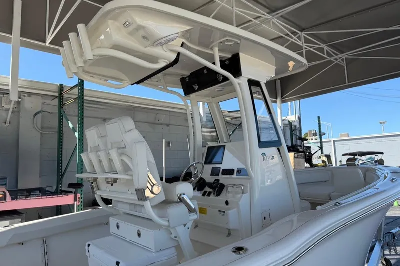 Slide: The Image of 2026 Key West 239 FSR boat under canopy, featuring modern helm and seating. - 7