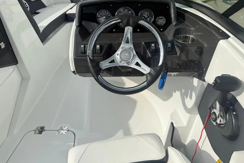 Slide: The Image of 2022 Monterey M-225 boat cockpit with steering wheel and controls. - 7