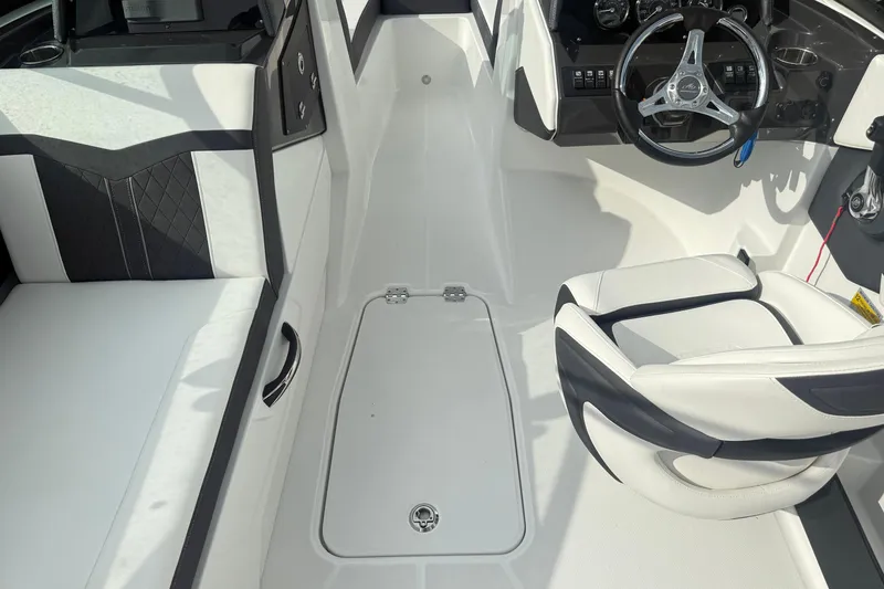 Slide: The Image of 2022 Monterey M-225 boat interior with sleek white seating and modern steering console. - 8