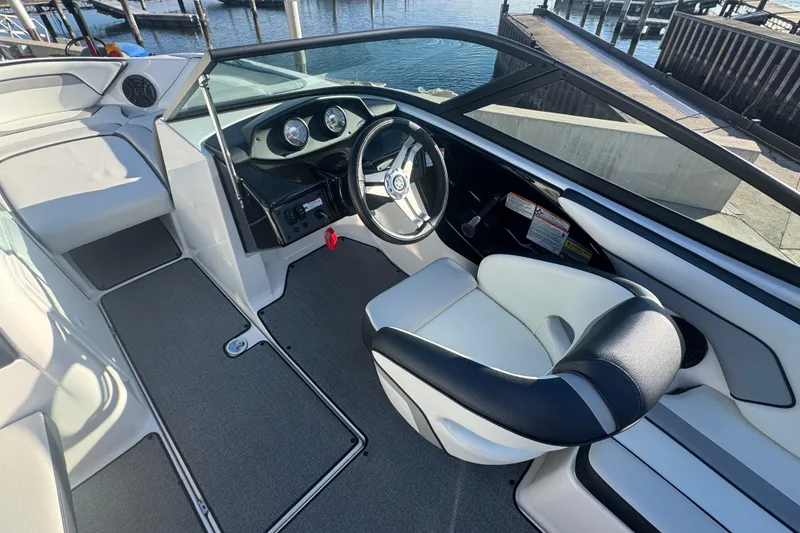 Slide: The Image of 2018 Yamaha AR195 boat interior with steering wheel and seating. - 12