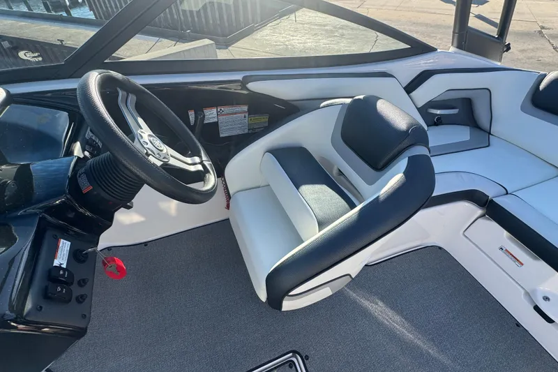 Slide: The Image of 2018 Yamaha AR195 boat interior with steering wheel and seating area. - 13