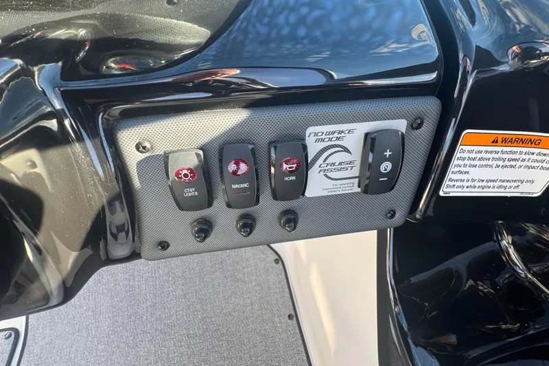 Slide: The Image of Control panel of 2018 Yamaha Boats AR195 with various switches and warning label. - 15