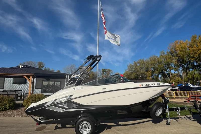 Slide: The Image of 2018 Yamaha Boats AR195 on trailer by lakeside, surrounded by autumn foliage. - 5