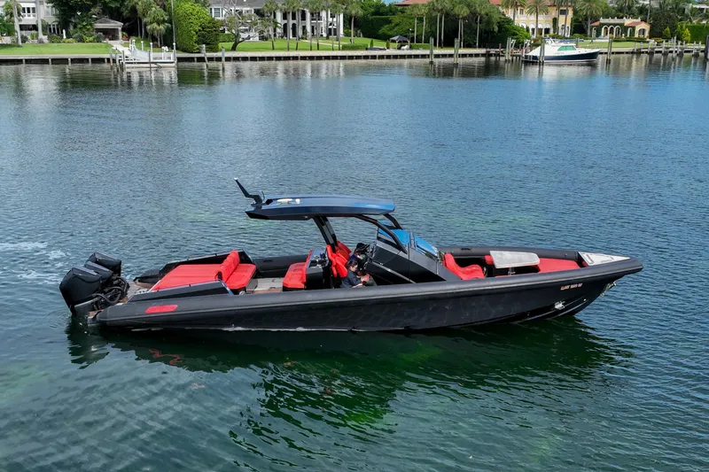 The Image of 2023 Skipper-BSK 42NC boat with red seating on calm water. - 0
