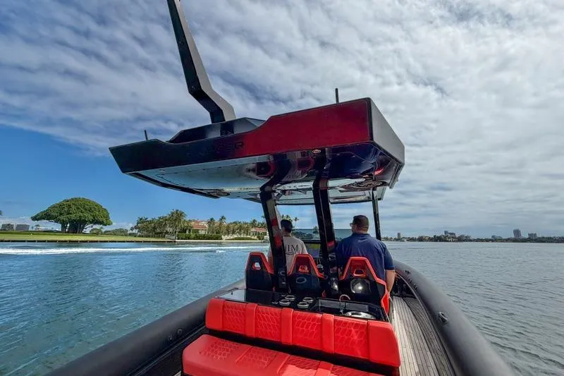 Slide: The Image of 2023 Skipper-BSK 42NC boat cruising on a scenic waterway under a partly cloudy sky. - 14