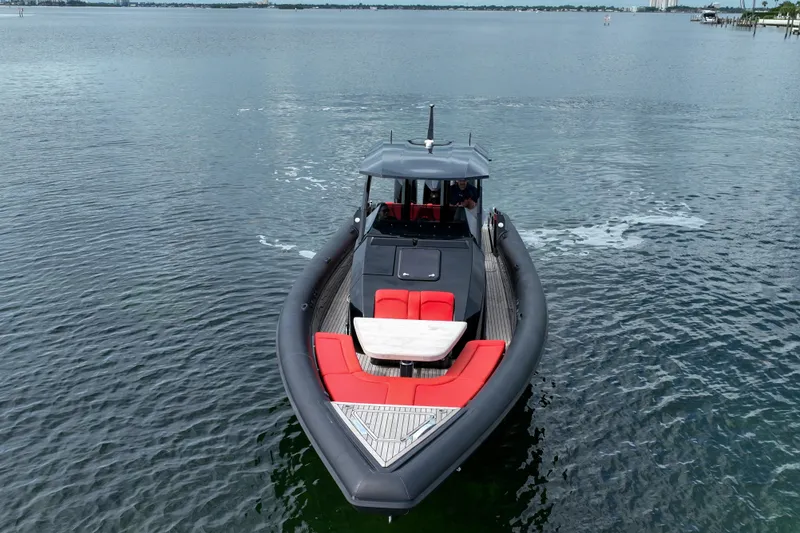 Slide: The Image of 2023 Skipper-BSK 42NC boat with red seating, cruising on calm waters. - 2
