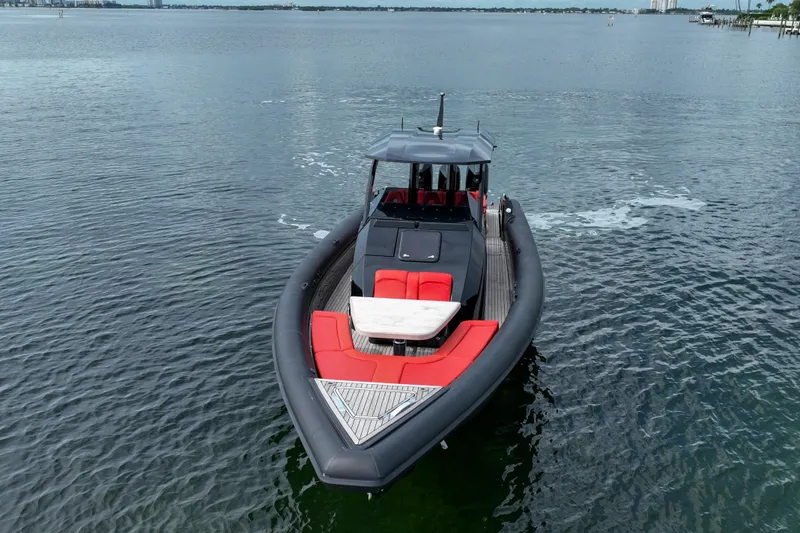 Slide: The Image of 2023 Skipper-BSK 42NC boat with red seating on calm water. - 3