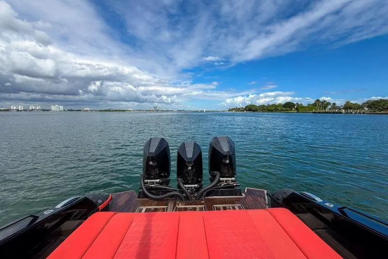 Slide: The Image of 2023 Skipper-BSK 42NC boat with triple engines on a scenic waterway. - 8