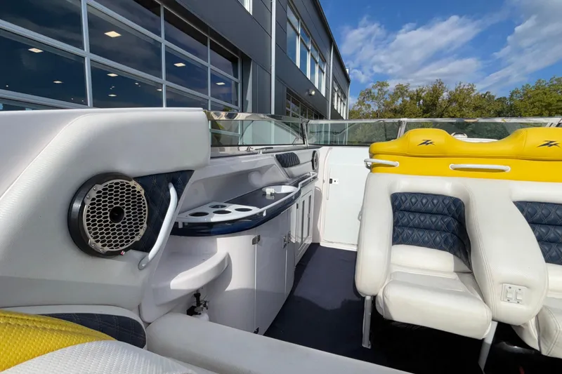 Slide: The Image of Interior of 2002 Donzi 45 ZX boat with yellow and white seating, speaker, and cabinetry. - 11