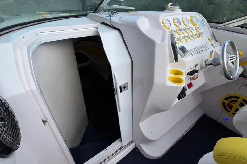 Slide: The Image of 2002 Donzi 45 ZX boat cockpit with steering wheel and control panel. - 27