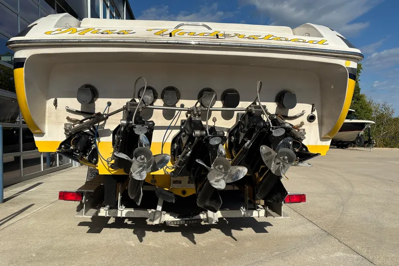 Slide: The Image of 2002 Donzi 45 ZX boat with multiple propellers, parked outdoors. - 3
