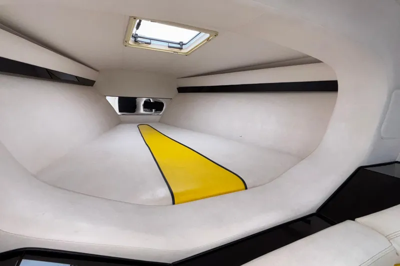 Slide: The Image of Interior cabin of 2002 Donzi 45 ZX boat with white and yellow accents. - 31