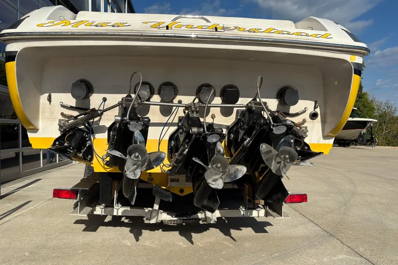 Slide: The Image of Rear view of a 2002 Donzi 45 ZX boat with triple propellers. - 4