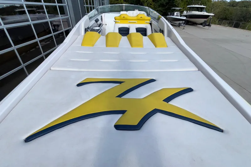 Slide: The Image of 2002 Donzi 45 ZX boat with yellow accents and logo, docked outdoors. - 43