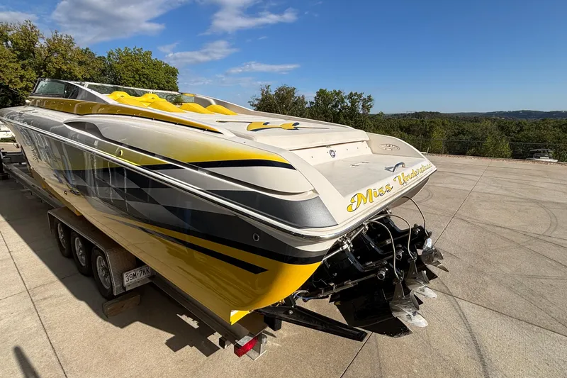 Slide: The Image of 2002 Donzi 45 ZX powerboat with yellow accents on a trailer, parked outdoors. - 5