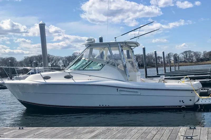The Image of 2002 Stamas 340 Express boat docked at marina under blue sky. - 0