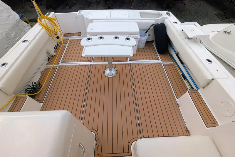 Slide: The Image of 2002 Stamas 340 Express boat deck with teak flooring and fishing setup. - 12