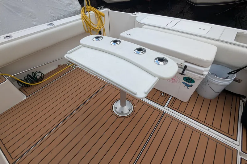 Slide: The Image of 2002 Stamas 340 Express boat deck with rod holders and teak flooring. - 13