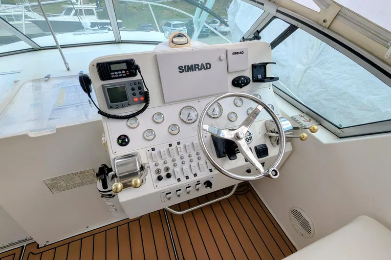 Slide: The Image of Helm of 2002 Stamas 340 Express boat with Simrad navigation system and control panel. - 18