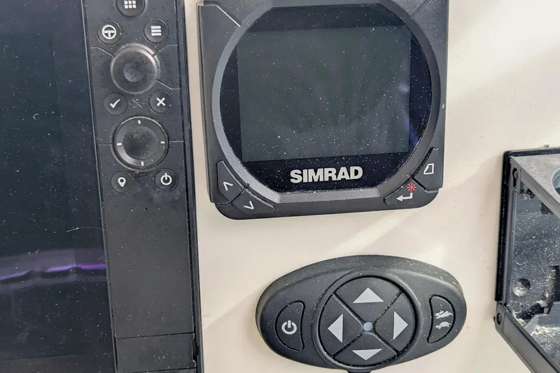 Slide: The Image of Simrad marine electronics on 2002 Stamas 340 Express boat dashboard. - 22