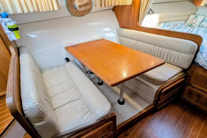 Slide: The Image of 2002 Stamas 340 Express cabin with cozy dining area and wooden table. - 26