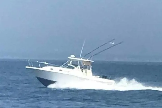 Slide: The Image of 2002 Stamas 340 Express boat cruising on open water. - 3