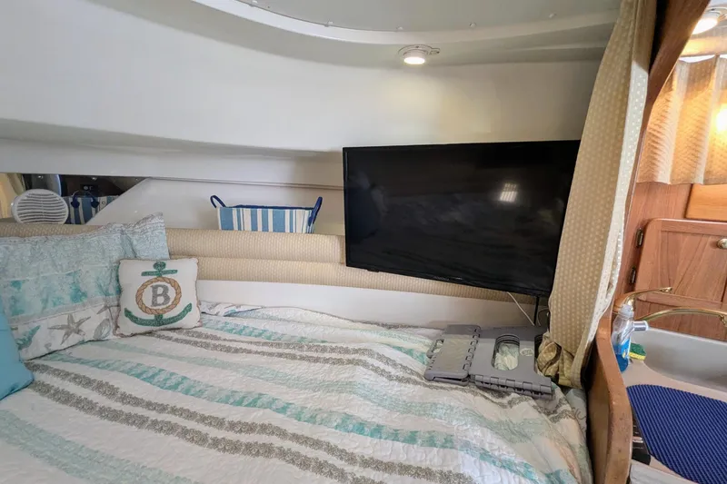 Slide: The Image of Cozy cabin interior of 2002 Stamas 340 Express with bed, TV, and nautical decor. - 32