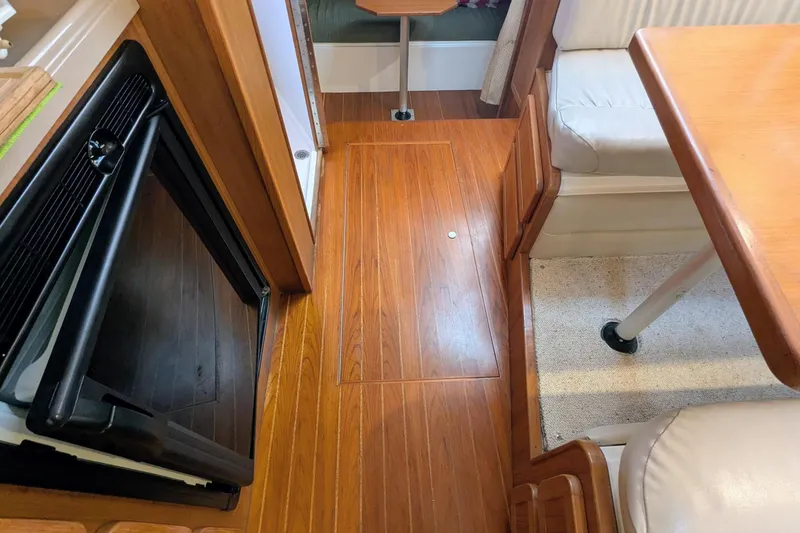 Slide: The Image of Interior of 2002 Stamas 340 Express boat with wood flooring and seating area. - 33