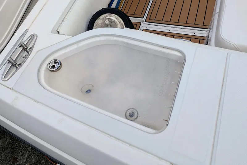 Slide: The Image of Livewell on 2002 Stamas 340 Express boat, featuring teak-style flooring. - 39