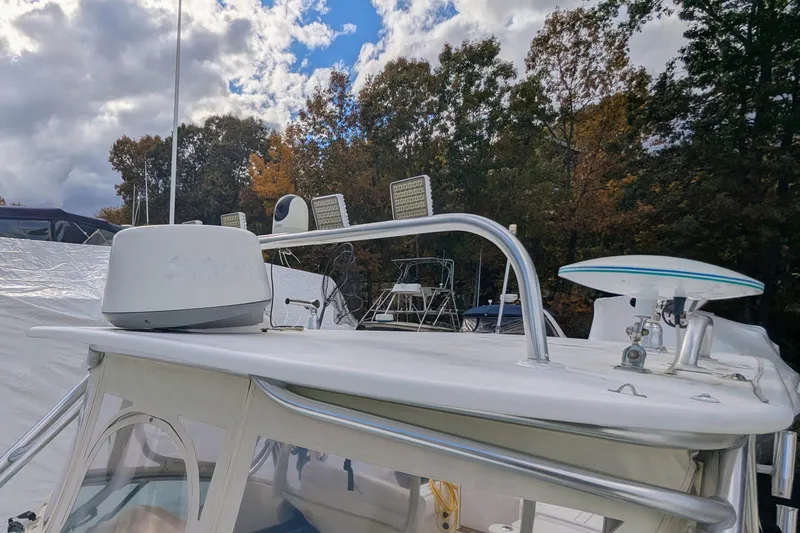 Slide: The Image of 2002 Stamas 340 Express boat with radar and antenna, docked under cloudy sky. - 42