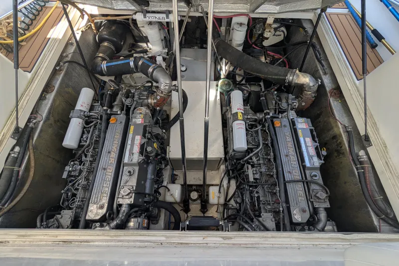 Slide: The Image of Engine compartment of a 2002 Stamas 340 Express boat, featuring dual Yanmar diesel engines. - 44