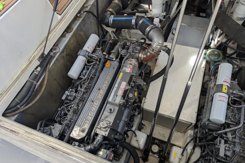 Slide: The Image of Engine compartment of a 2002 Stamas 340 Express boat, featuring Yanmar diesel engines. - 45