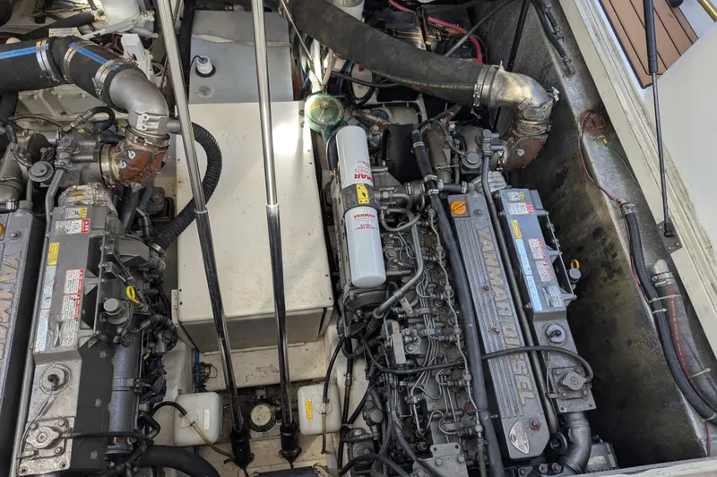 Slide: The Image of Engine compartment of a 2002 Stamas 340 Express boat, featuring Yanmar diesel engines. - 46