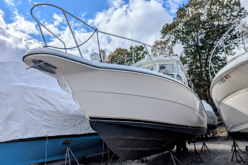 Slide: The Image of 2002 Stamas 340 Express boat on stands, under a partly cloudy sky. - 5