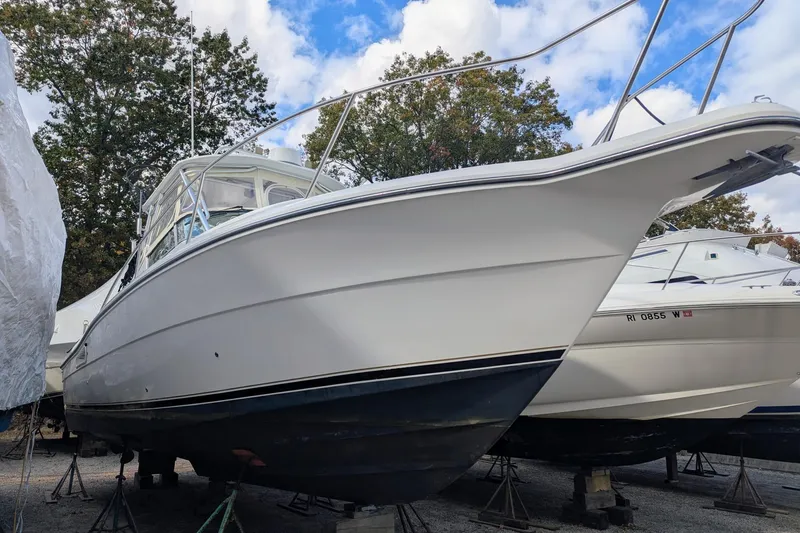 Slide: The Image of 2002 Stamas 340 Express boat on stands, surrounded by trees and blue sky. - 6