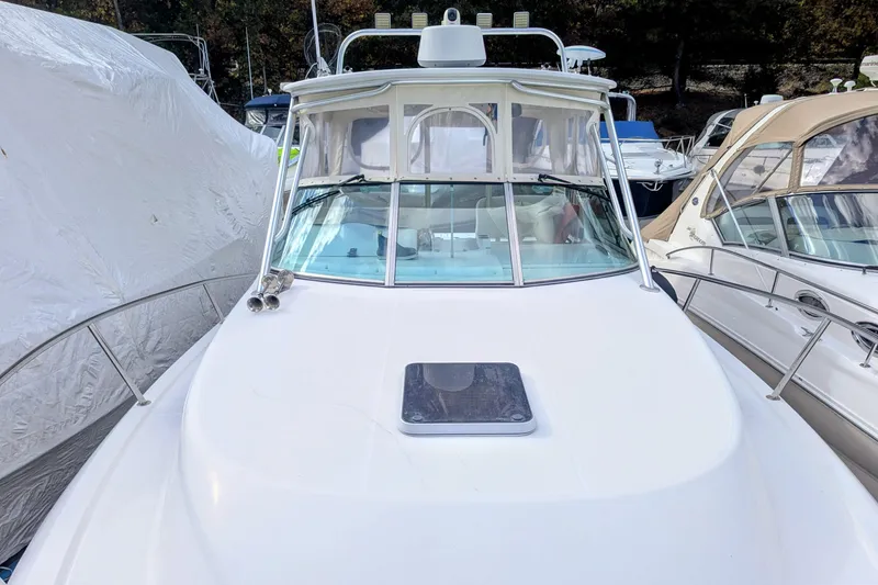 Slide: The Image of 2002 Stamas 340 Express boat docked among other vessels at a marina. - 7