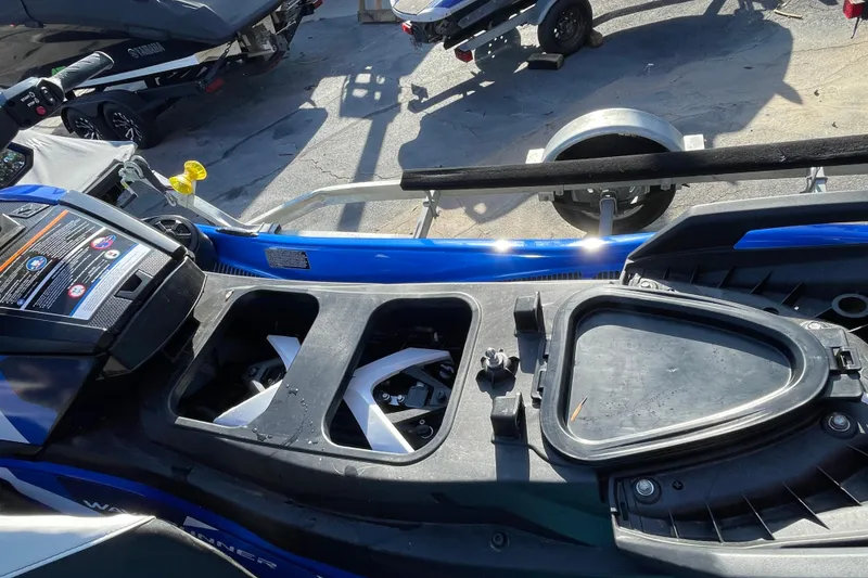 Slide: The Image of 2024 Yamaha WaveRunner VX Cruiser HO with open storage compartments, parked on a trailer. - 8