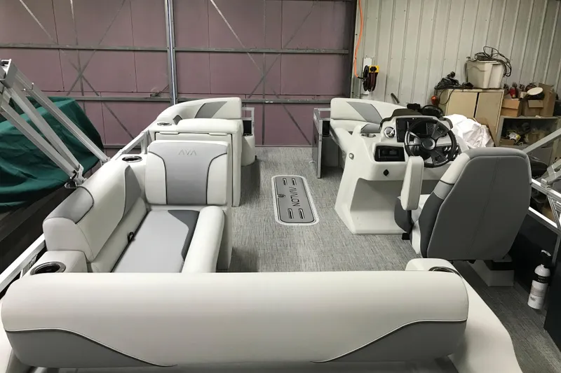 Slide: The Image of 2026 Avalon Venture 85 Versatile Rear Bench boat interior with modern seating and steering console. - 2