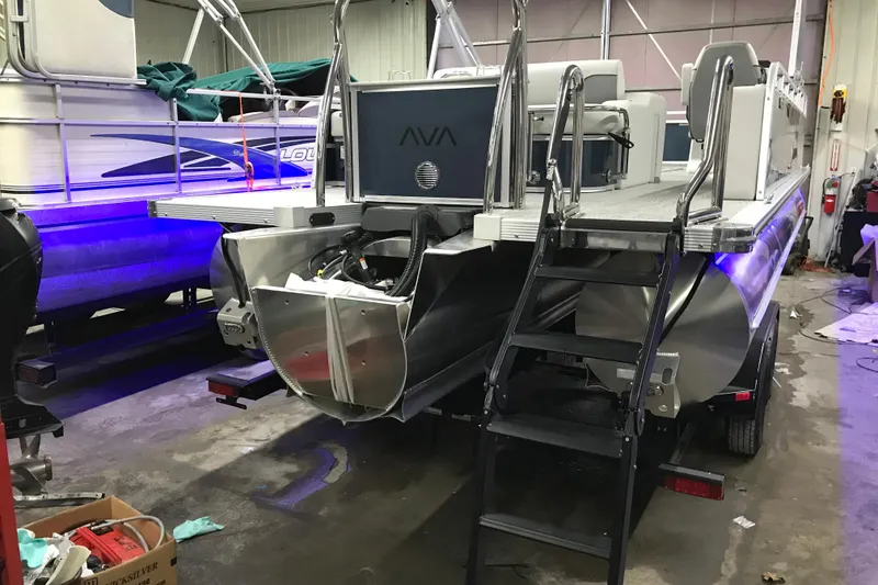 Slide: The Image of 2026 Avalon Venture 85 Versatile rear Bench pontoon boat in a workshop setting. - 26