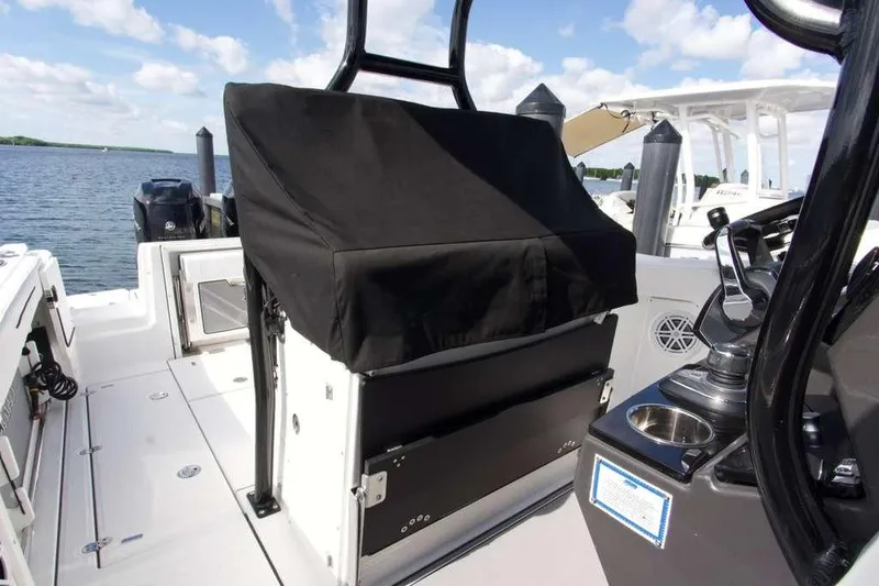 Slide: The Image of 2023 Blackfin 302 CC boat interior with covered seating and control panel. - 16
