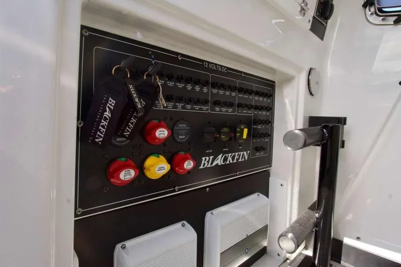 Slide: The Image of Control panel of 2023 Blackfin 302 CC boat with labeled switches and key fobs. - 22