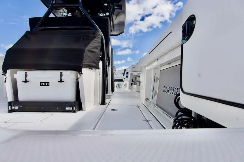 Slide: The Image of 2023 Blackfin 302 CC boat deck with Yeti cooler and clear blue sky. - 24