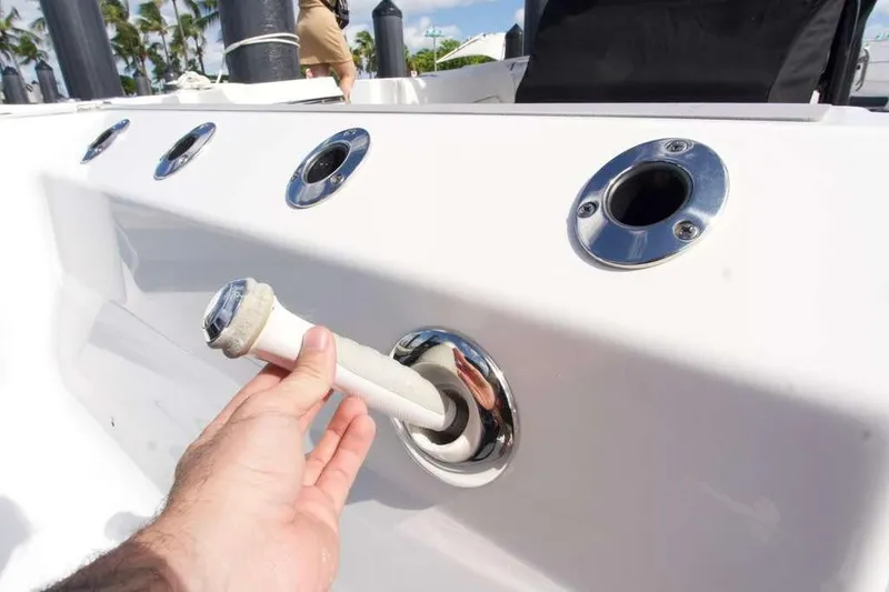 Slide: The Image of Hand holding a hose on a 2023 Blackfin 302 CC boat deck. - 27