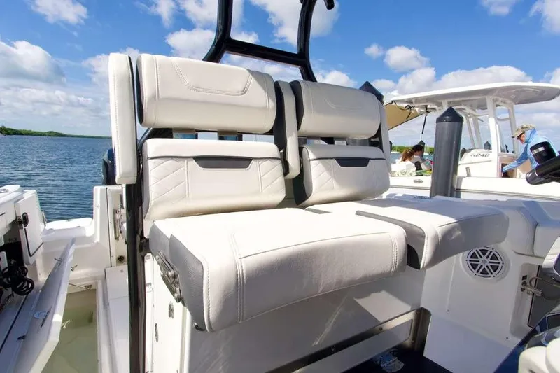 Slide: The Image of 2023 Blackfin 302 CC boat interior with white seating and scenic water view. - 33