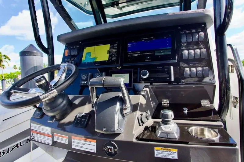 Slide: The Image of 2023 Blackfin 302 CC boat dashboard with advanced navigation and control systems. - 34